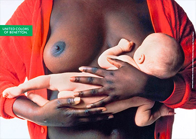 foto Oliviero Toscani Benetton donna nera allatta bambino bianco